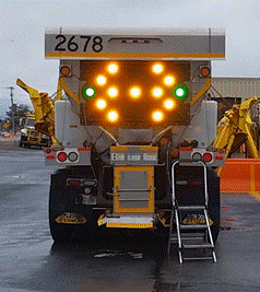 A back of a truck with lights on  Description automatically generated